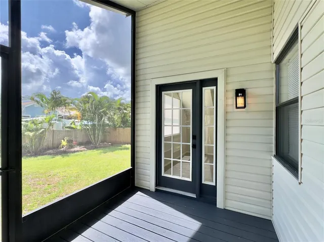 an aerial view of a house with a yard and large trees