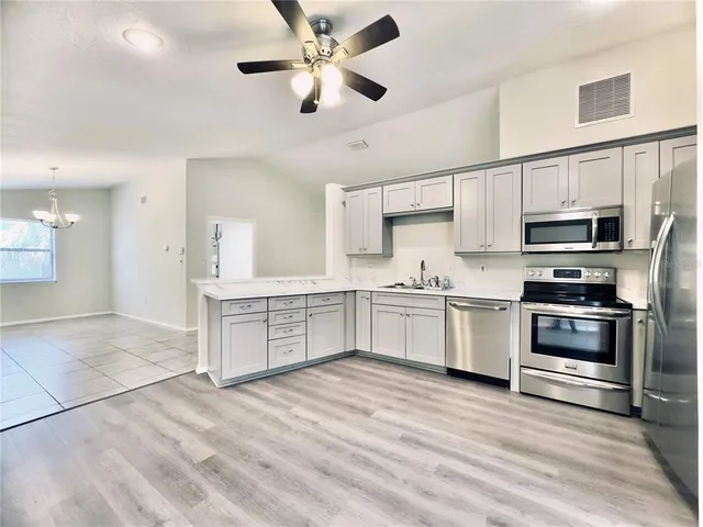 a dining room with a wooden table and chairs