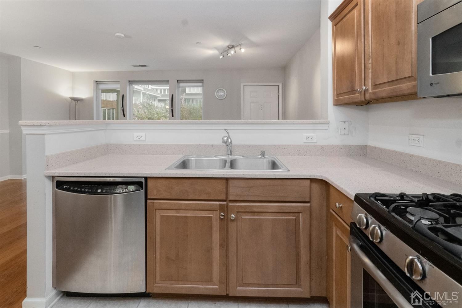 368 Rector Street, Unit 422 Perth Amboy, NJ 08861 - Photo 8 of 17 a kitchen with stainless steel appliances granite countertop a sink stove and cabinets