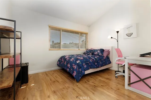 a bedroom with a bed window and a table