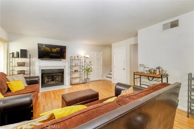 a living room with fireplace furniture and a flat screen tv