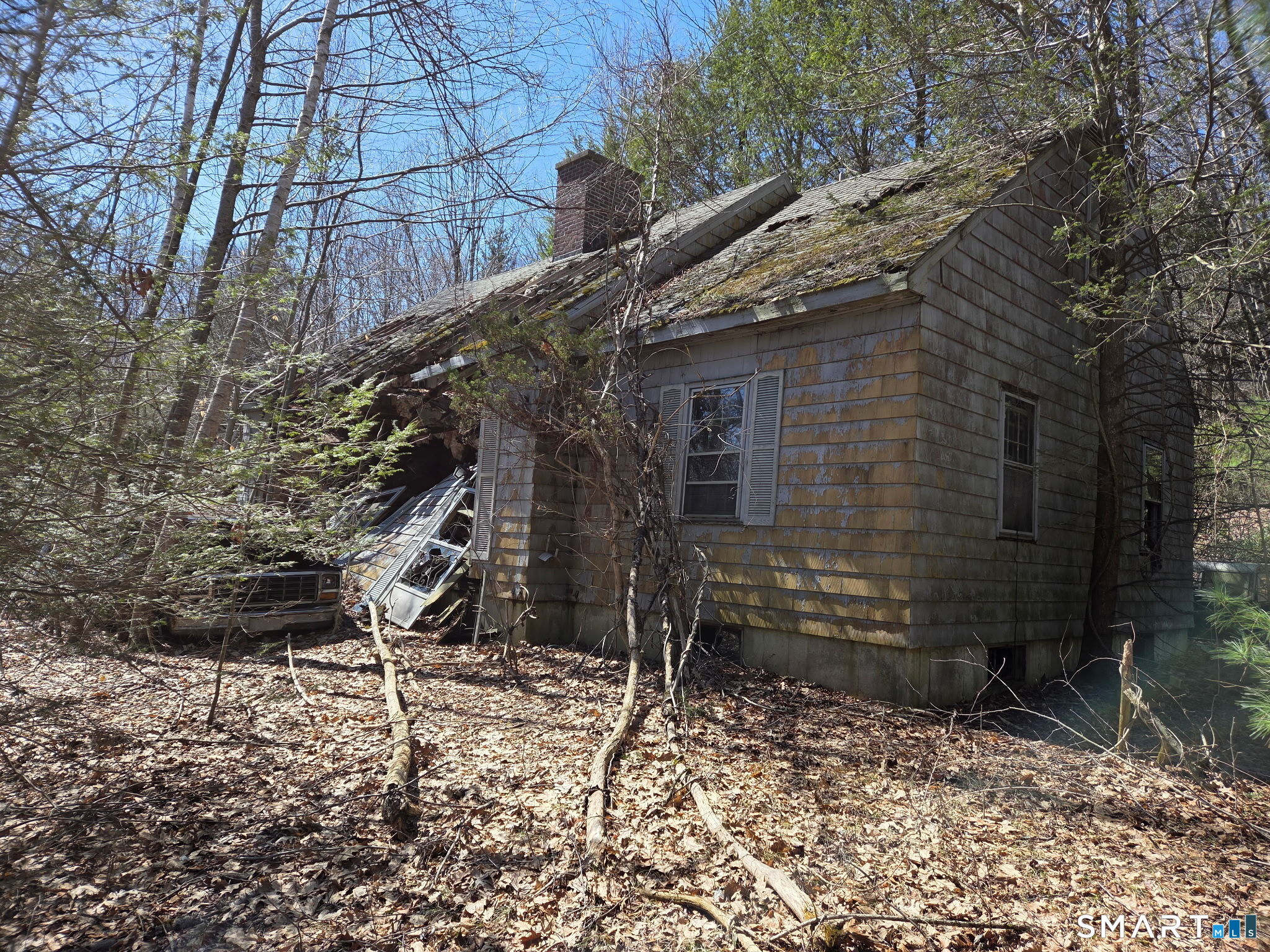 a brick building with a tree in the yard