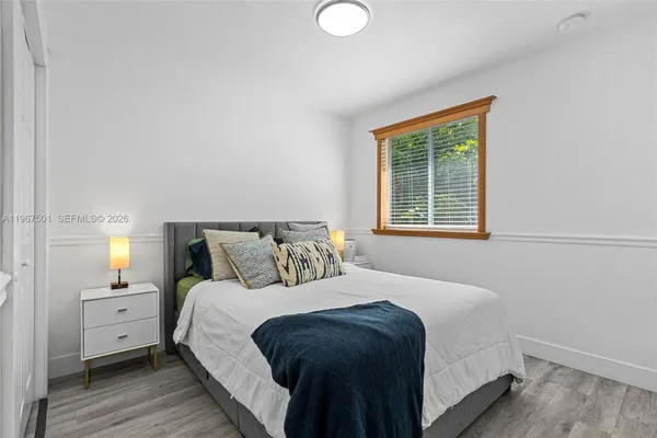 a bedroom with a bed and a window