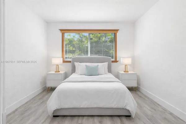 a bedroom with a bed and window