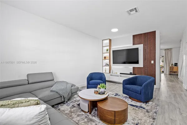a living room with furniture and a flat screen tv