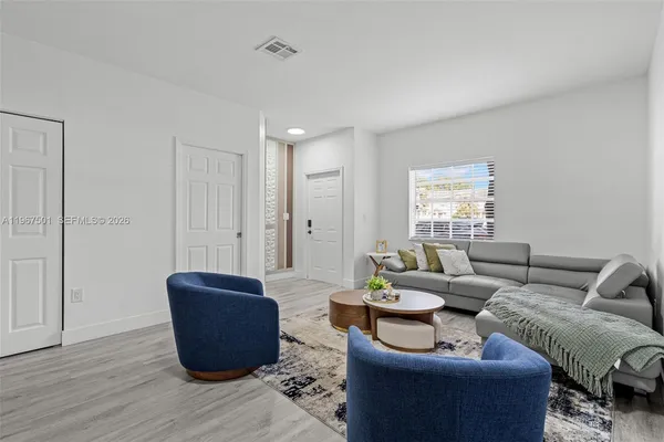 a living room with furniture and a potted plant