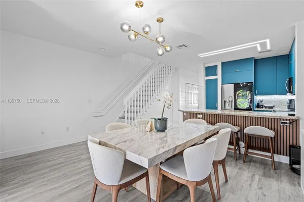 a view of a dining room with furniture and wooden floor
