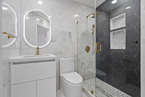 a bathroom with a toilet sink and shower