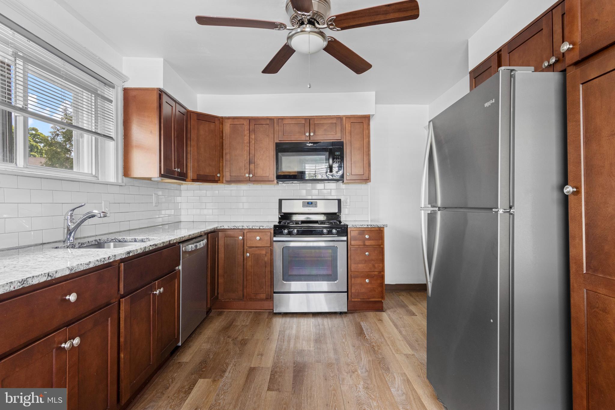 153 Conestoga Road Wayne, PA 19087 - Photo 3 of 13 a kitchen with a refrigerator and a sink