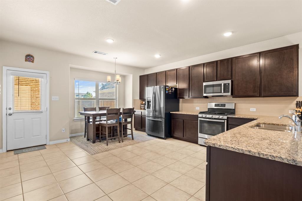 4207 Whispering Willow Way Arlington, TX 76005 - Photo 14 of 31 a kitchen with granite countertop stainless steel appliances a sink counter tops and a window