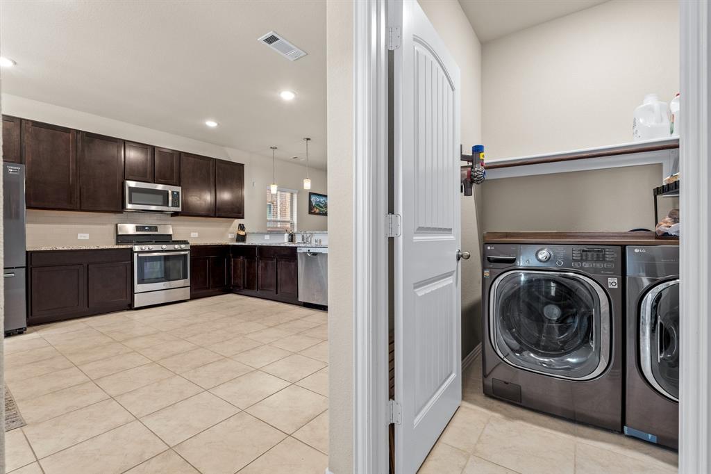 4207 Whispering Willow Way Arlington, TX 76005 - Photo 18 of 31 a kitchen with kitchen island a sink stainless steel appliances and cabinets