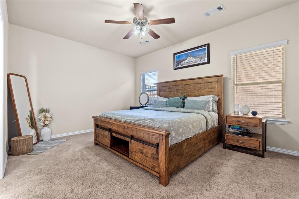 4207 Whispering Willow Way Arlington, TX 76005 - Photo 19 of 31 a bedroom with a bed and a chandelier