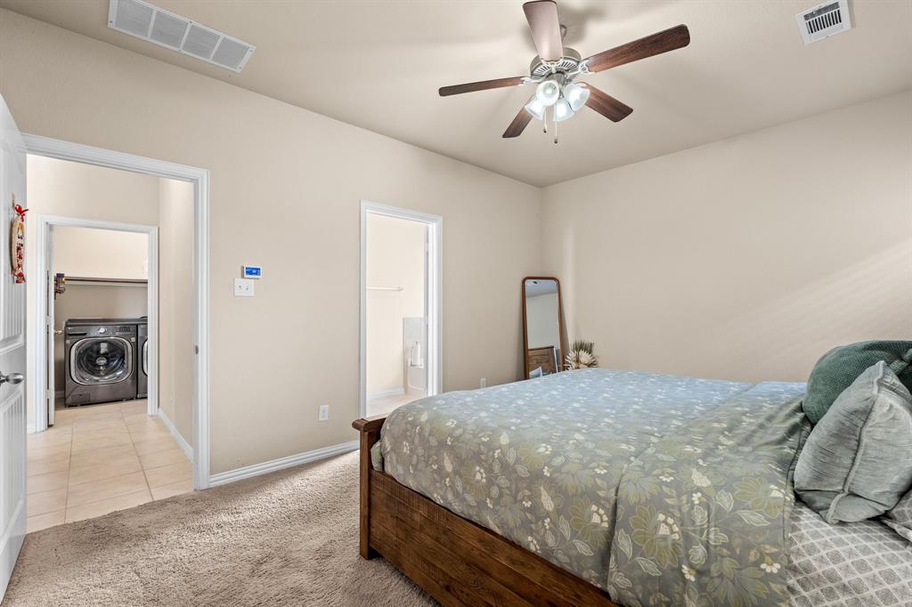 4207 Whispering Willow Way Arlington, TX 76005 - Photo 20 of 31 a bedroom with a bed and a chandelier