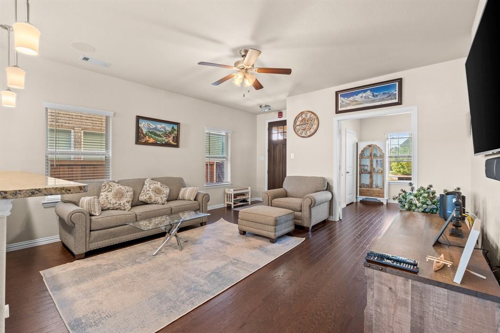 4207 Whispering Willow Way Arlington, TX 76005 - Photo 5 of 31 a living room with couches a fireplace and a flat screen tv