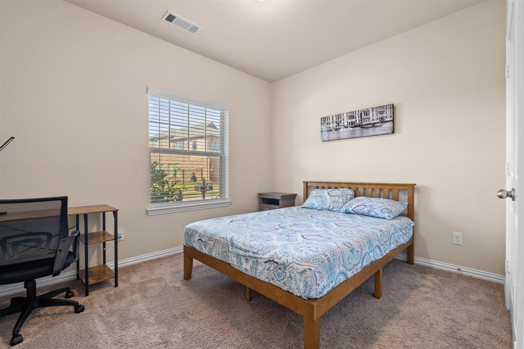 4207 Whispering Willow Way Arlington, TX 76005 - Photo 9 of 31 a bedroom with a bed and a desk