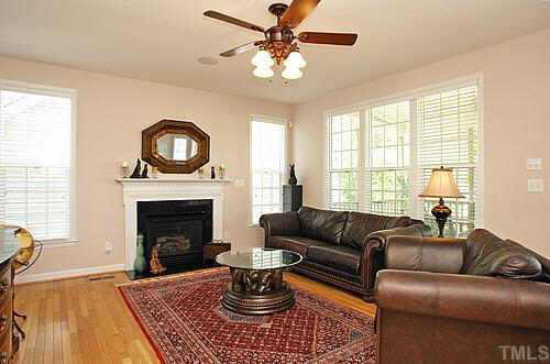 5900 Currin Fox Court Raleigh, NC 27616 - Photo 4 of 10 a living room with furniture a window and a fireplace