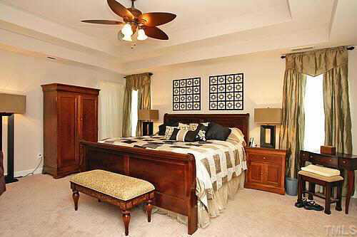 5900 Currin Fox Court Raleigh, NC 27616 - Photo 7 of 10 a bedroom with a bed a table and chair