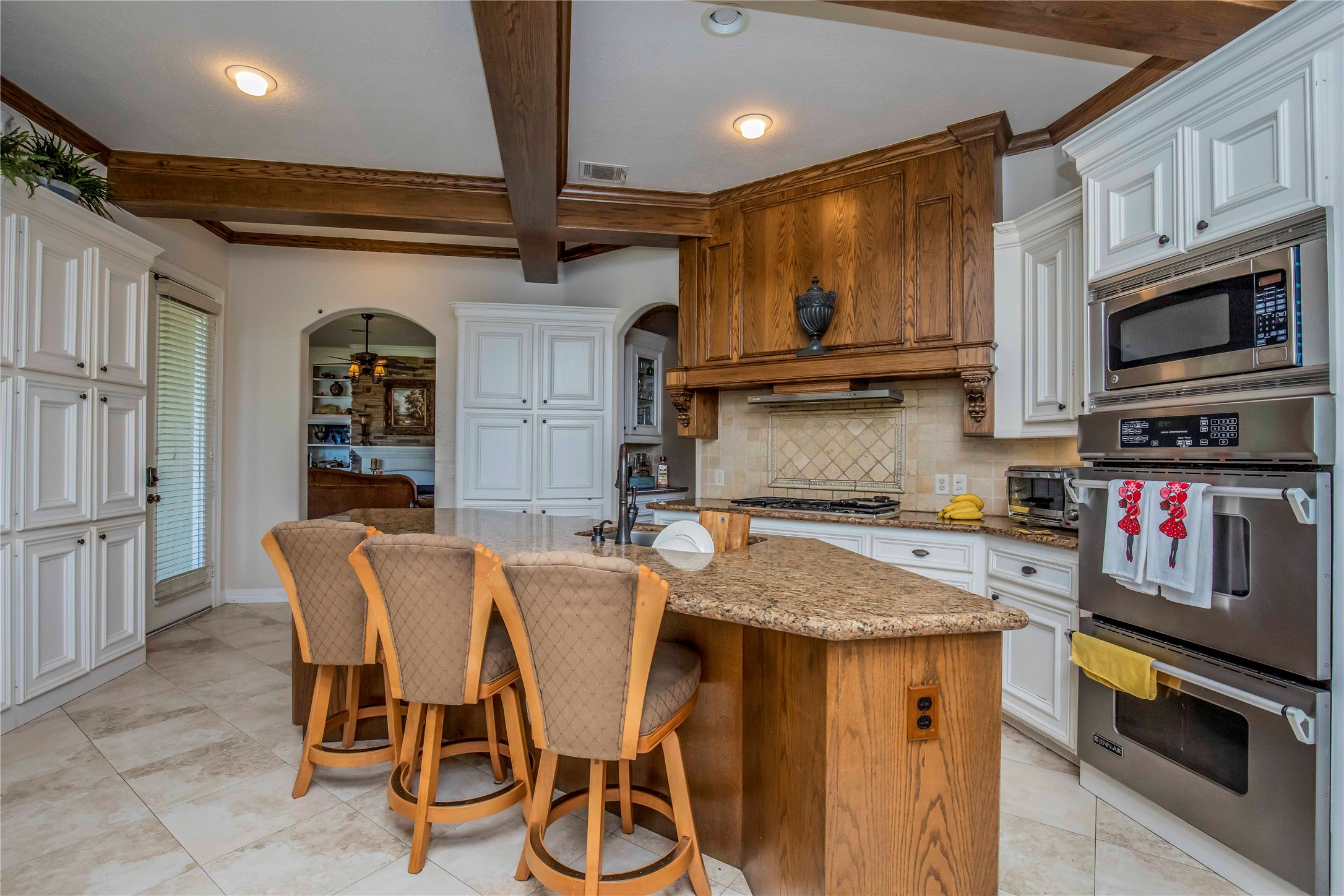 25219 Hideaway Run Drive Spring, TX 77389 - Photo 21 of 45 a kitchen with stainless steel appliances granite countertop a kitchen island a table and chairs