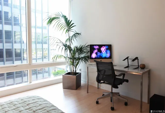 a workspace with furniture and a potted plant
