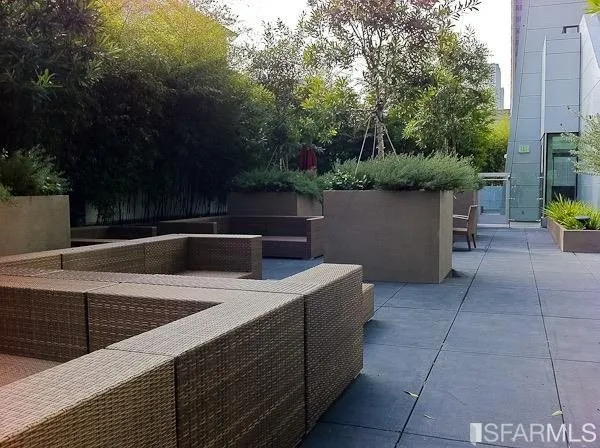 a building outdoor space with patio furniture and potted plants