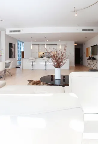 a kitchen with stainless steel appliances granite countertop a sink and a white cabinets