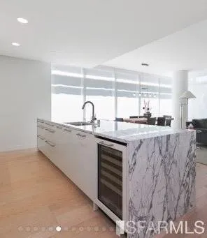 a kitchen with stainless steel appliances granite countertop a sink and a white cabinets