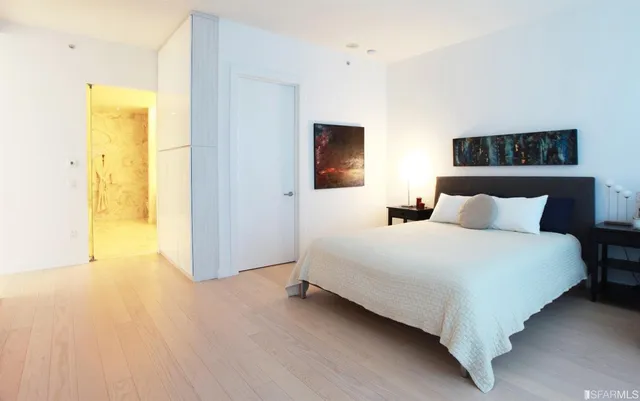 a bedroom with a bed and wall painting