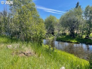 124 Woodland Road Goldendale, WA 98620 - Photo 1 of 27 a view of a lake with a building in the background