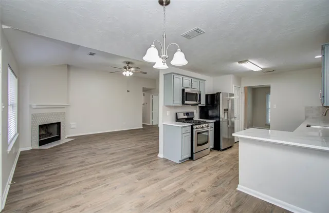 a kitchen with a refrigerator a stove top oven a sink and dishwasher