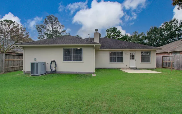 a house view with a sitting space and garden