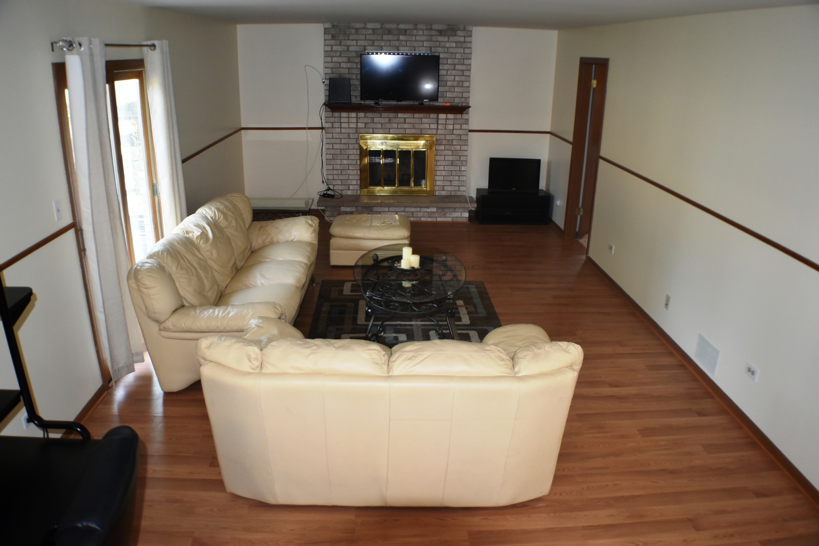 633 Gavin Avenue Romeoville, IL 60446 - Photo 13 of 33 a living room with furniture a flat screen tv and a fireplace