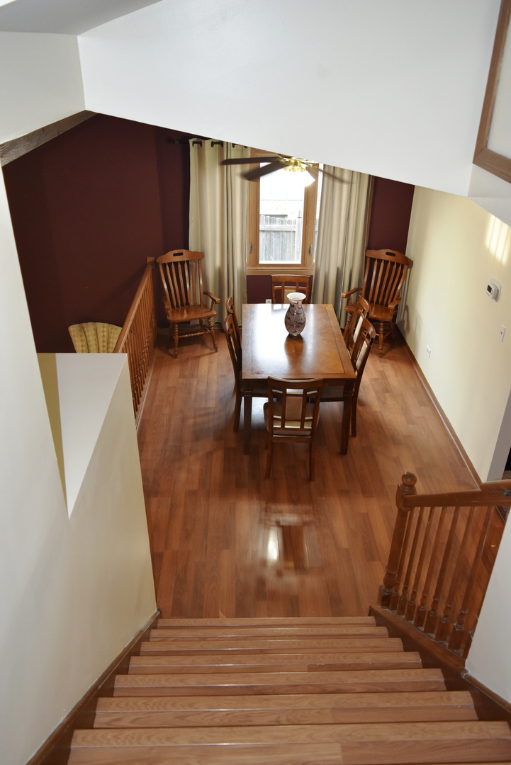 633 Gavin Avenue Romeoville, IL 60446 - Photo 7 of 33 a view of a dining room with furniture and wooden floor