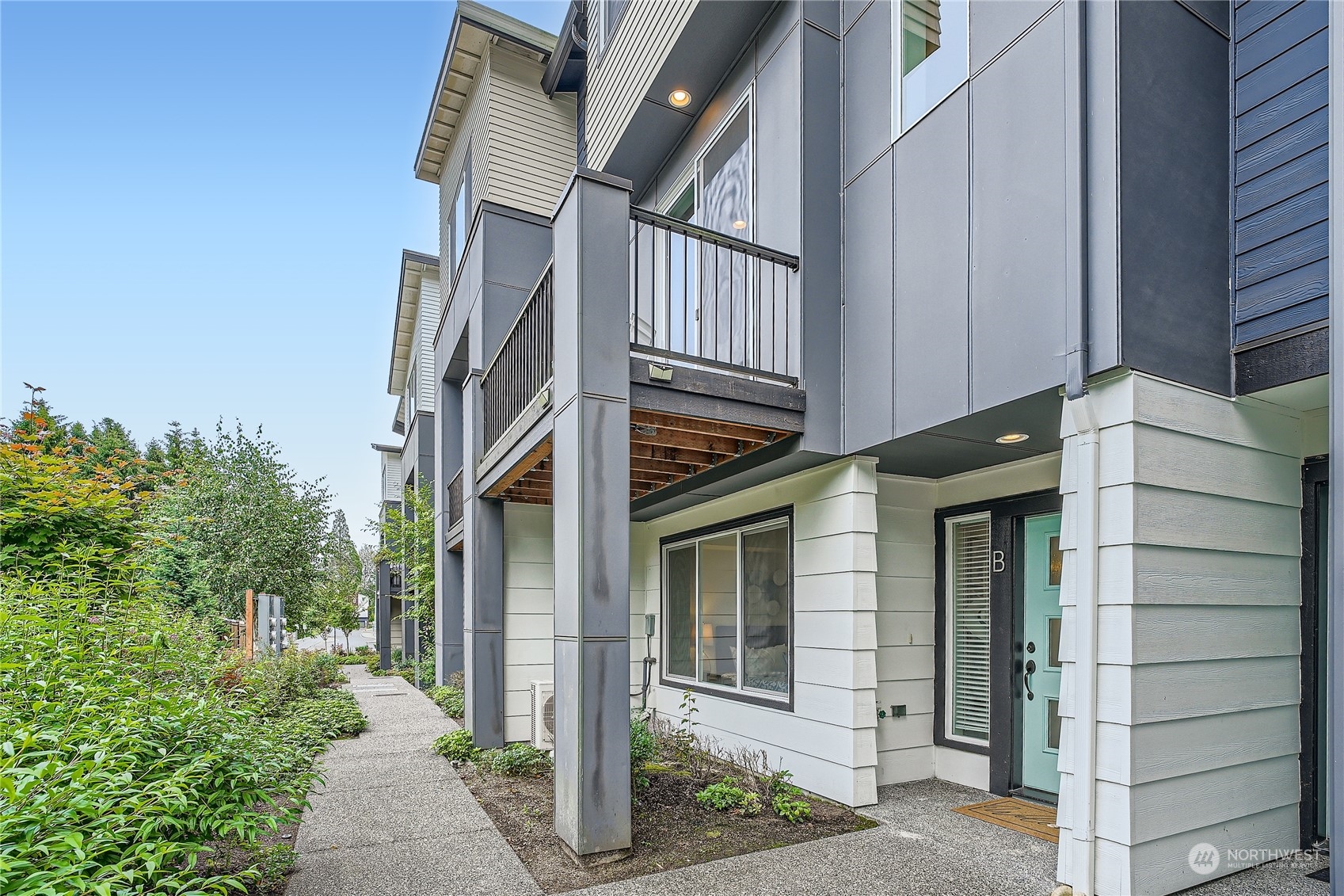 an outdoor view of a house with a tree