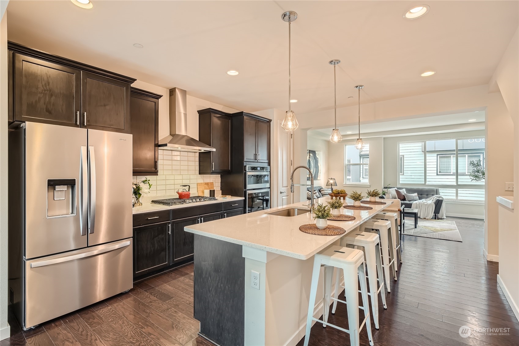 603 237th Street Southeast, Unit B Bothell, WA 98021 - Photo 10 of 27 a kitchen with stainless steel appliances a refrigerator a stove a dining table and chairs