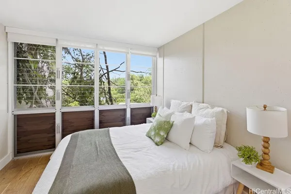 a bedroom with a bed and a window