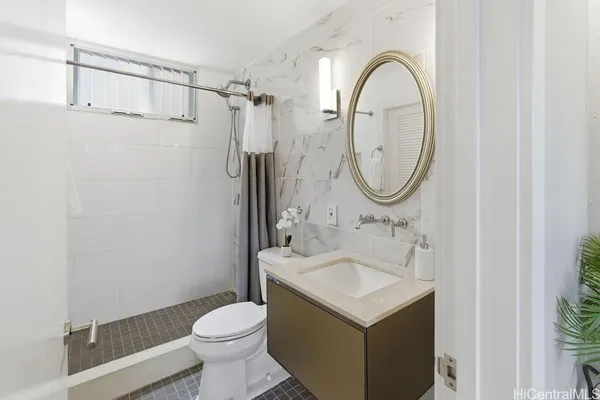 a bathroom with a sink a toilet and a mirror