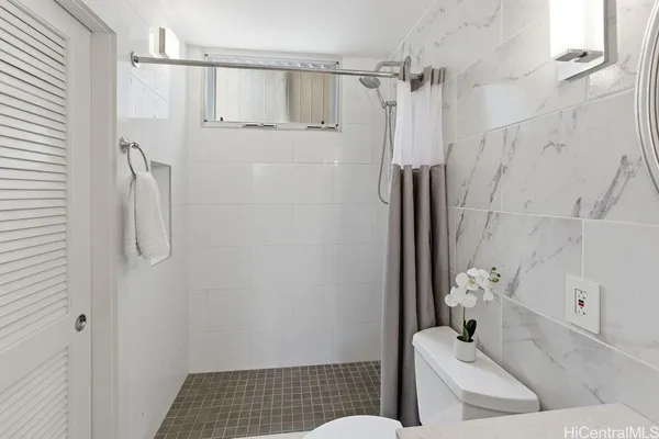 a bathroom with a shower and a sink