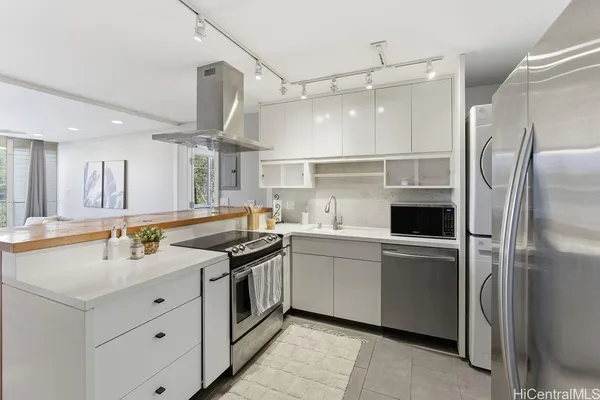 a kitchen with stainless steel appliances a sink stove and refrigerator