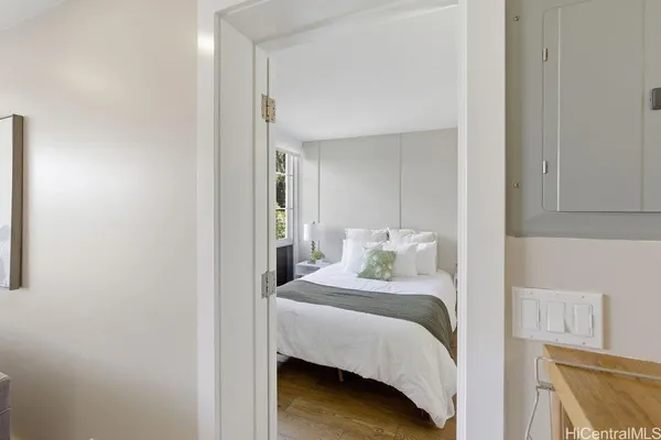 a bedroom with a bed and a mirror