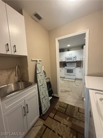 a kitchen with sink refrigerator and stove