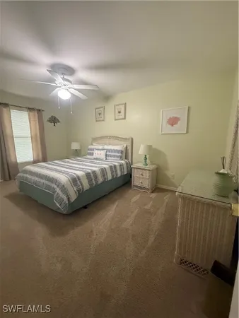 a spacious bedroom with a bed and a chandelier