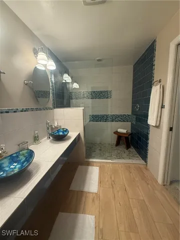 a bathroom with a granite countertop sink a toilet and a mirror