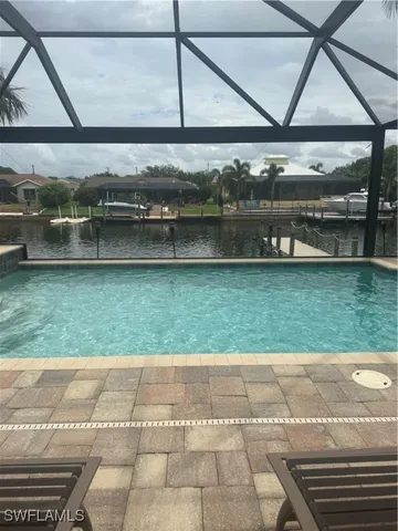 a view of swimming pool with outdoor seating
