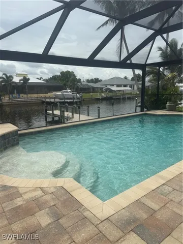 a view of a swimming pool with a yard