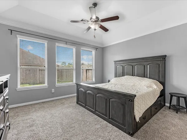 a bedroom with a bed and a television