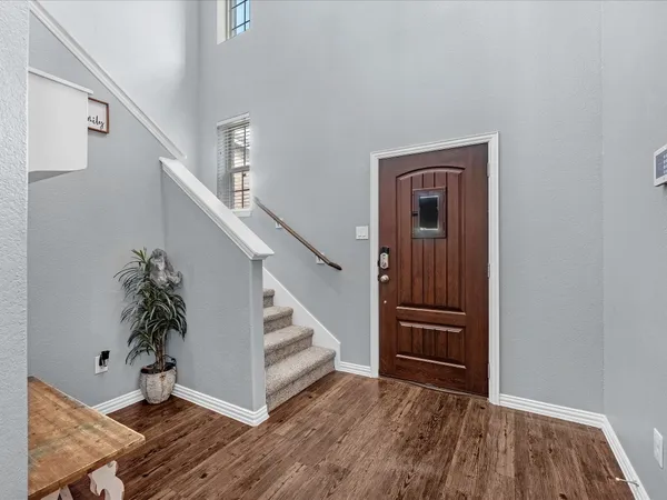 a view of entryway with stairs and wooden floor