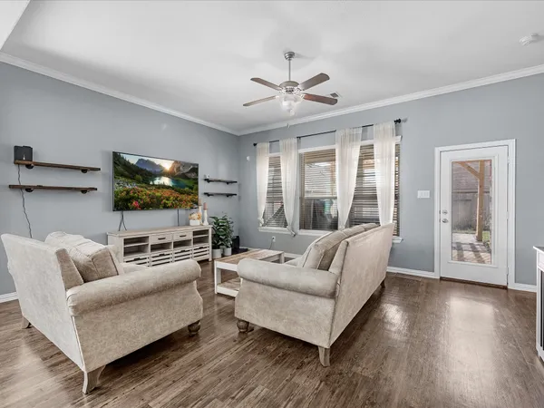 a living room with furniture and a flat screen tv