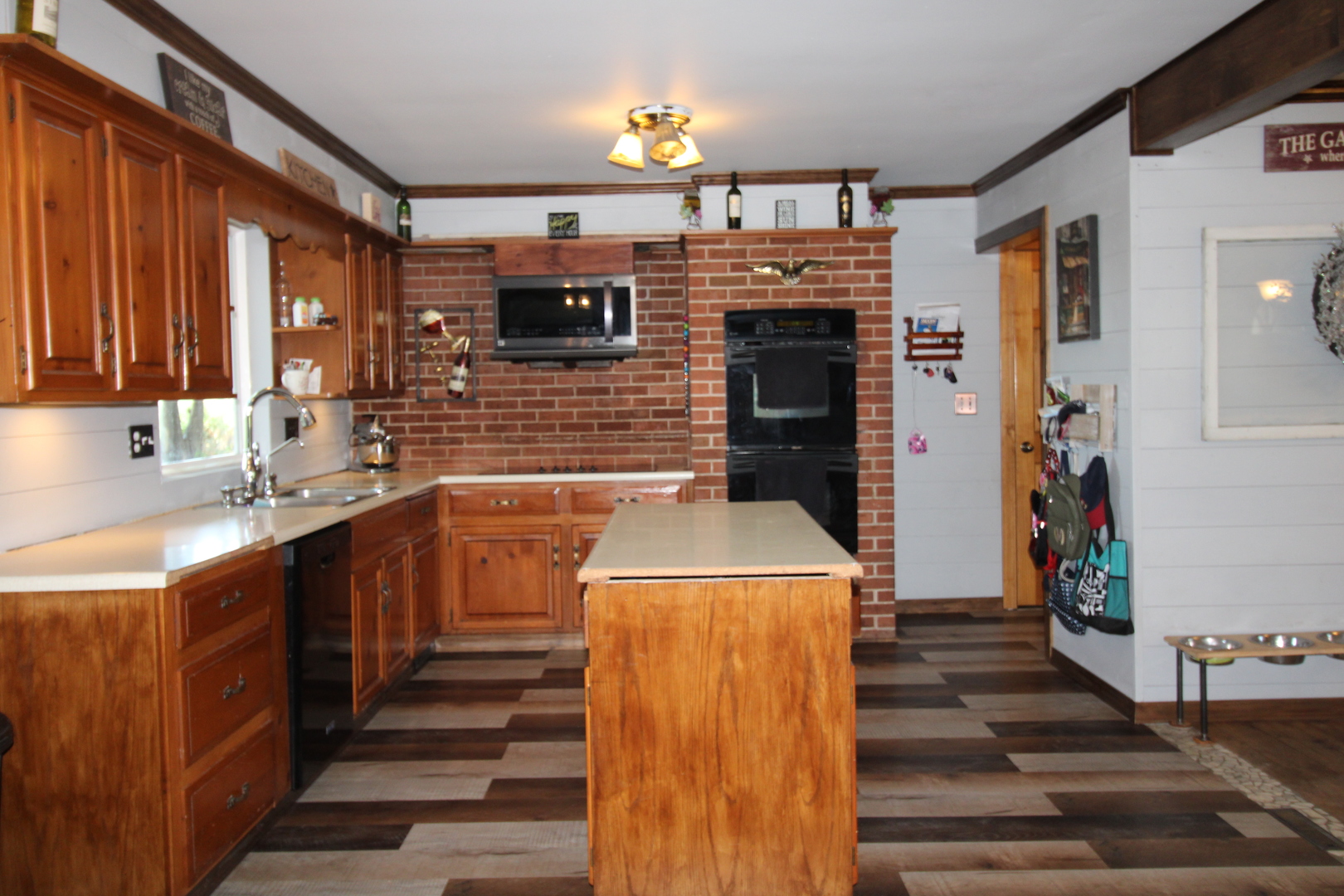 9033 Crego Road Waterman, IL 60556 - Photo 2 of 21 a kitchen view with wooden cabinets and a sink