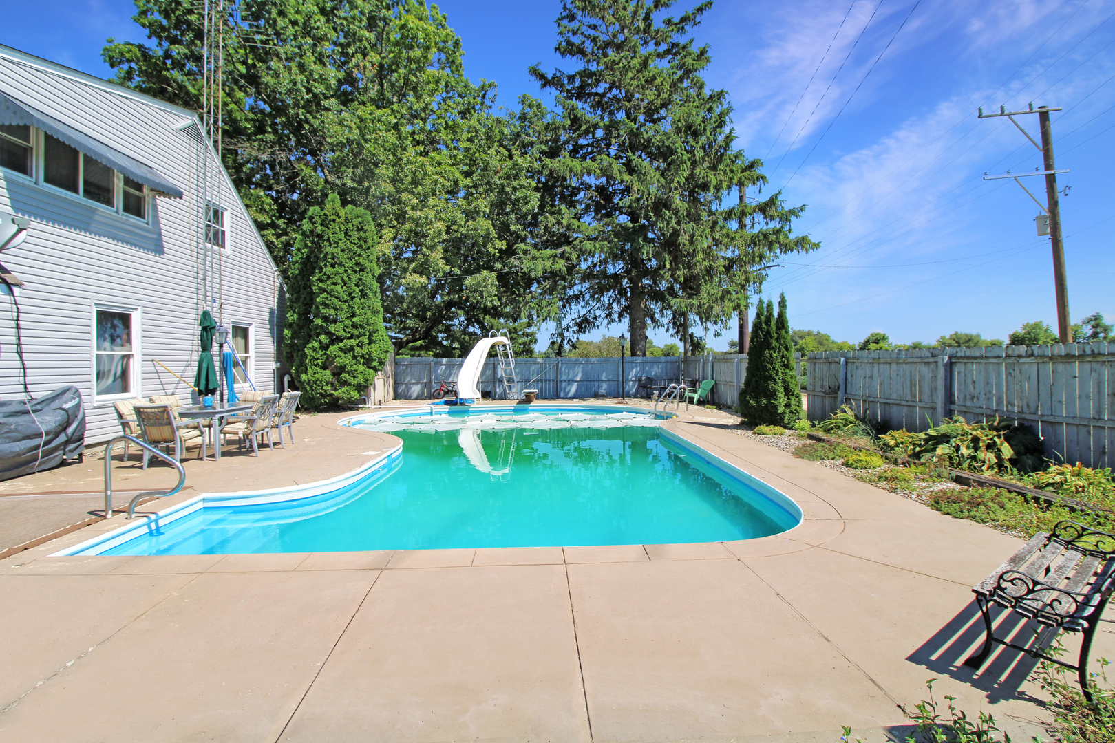 9033 Crego Road Waterman, IL 60556 - Photo 17 of 21 a view of a swimming pool with a lounge chairs