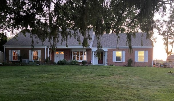 9033 Crego Road Waterman, IL 60556 - Photo 21 of 21 a large building with a big yard and large trees